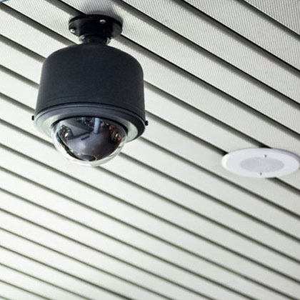 black cctv camera mounted on slatted ceiling